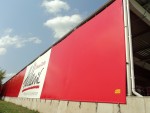 Coca-Cola HBC Polska, Radzymin - banner osłaniający z reklamą malowaną o wymiarach 12900cm x 540cm